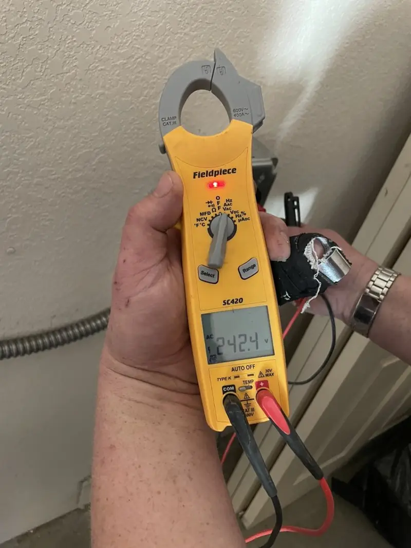 Voltage testing with clamp meter during Electrical Installation Services in Gilmer